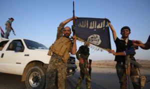 Iraqi Shiite militia fighters hold the Islamic State flag as they celebrate after breaking the siege of Amerli by Islamic State militants, September 1, 2014. Picture taken on September 1, 2014. REUTERS/Youssef Boudlal (IRAQ - Tags: CIVIL UNREST POLITICS MILITARY TPX IMAGES OF THE DAY) - RTR44N6G