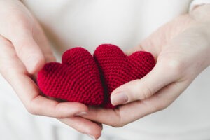 crop-hands-with-knitted-hearts_23-2147736882