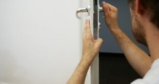 person holds door lever